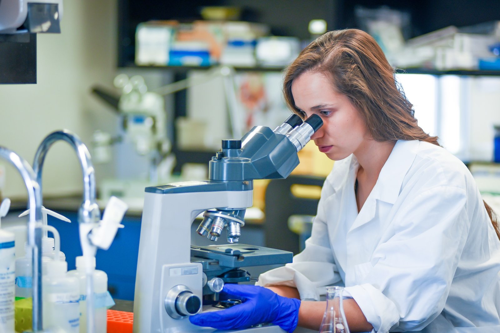 woman-researcher-examining-sample-under-microscope.jpg